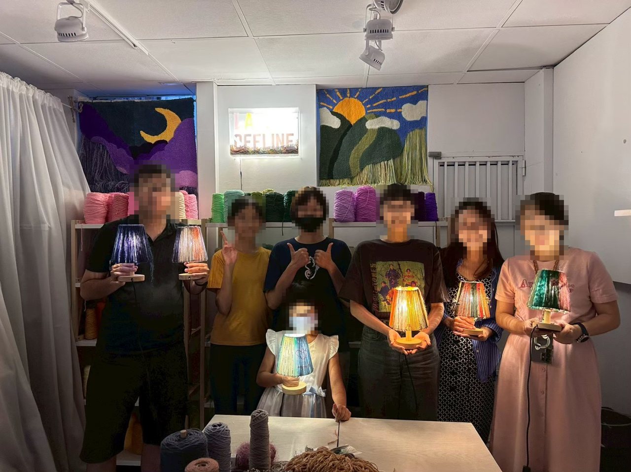 團體毛線燈手作課,學員捧著亮起的毛線燈合影